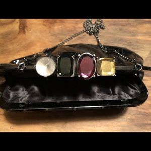 Jeweled patent leather knuckle clutch